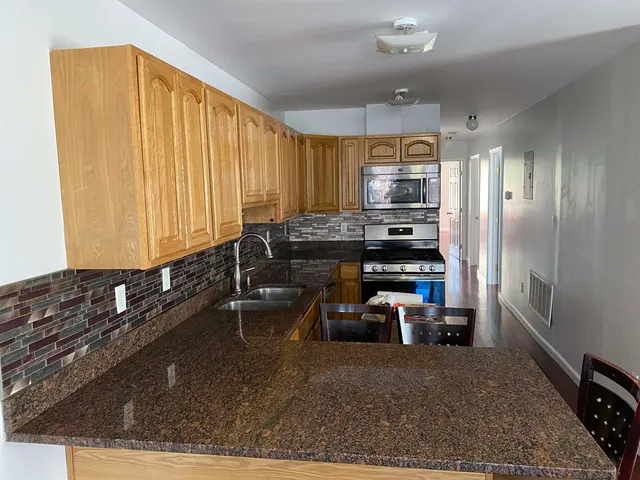 a kitchen with sink refrigerator and cabinets