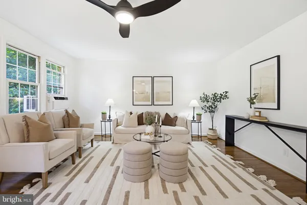 a living room with furniture or chandelier and a window