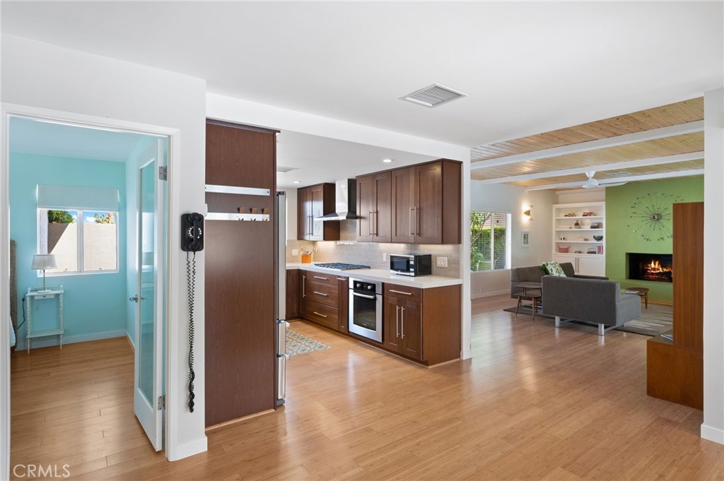 72543 Beavertail Street Palm Desert, CA 92260 - Photo 13 of 45 a kitchen with stainless steel appliances kitchen island granite countertop a refrigerator and a stove top oven