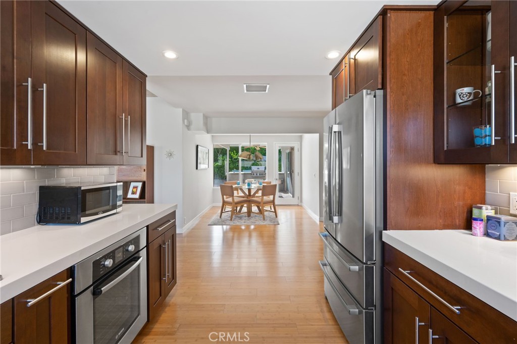 72543 Beavertail Street Palm Desert, CA 92260 - Photo 16 of 45 a kitchen with a table chairs refrigerator and cabinets