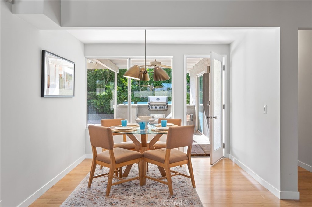 72543 Beavertail Street Palm Desert, CA 92260 - Photo 17 of 45 a dining room with furniture a chandelier and wooden floor