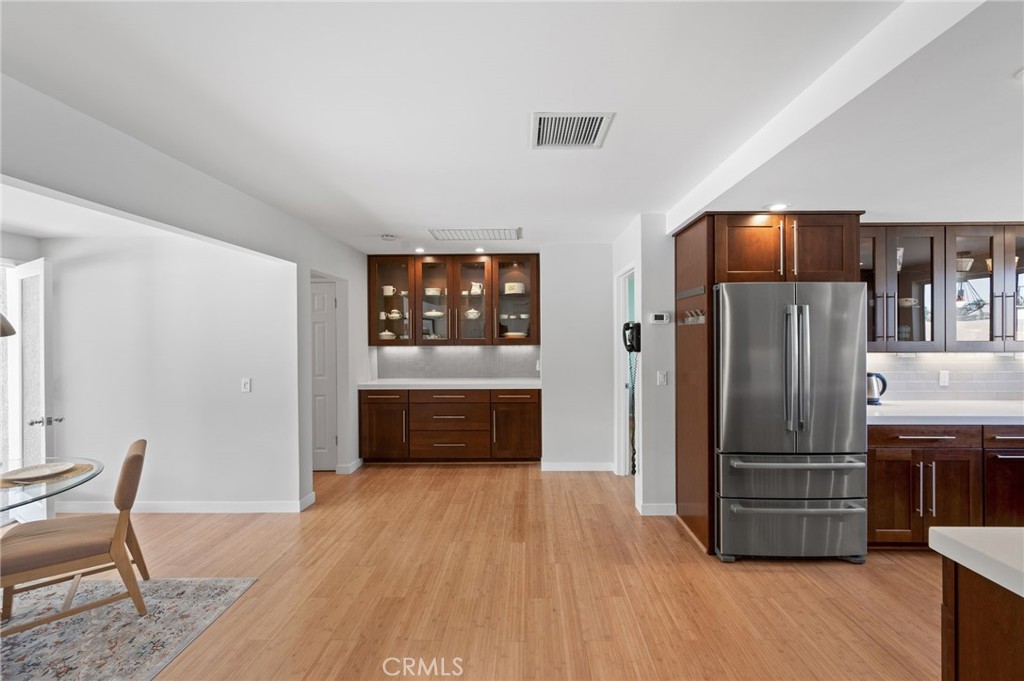 72543 Beavertail Street Palm Desert, CA 92260 - Photo 18 of 45 a kitchen with stainless steel appliances wooden floor and chairs