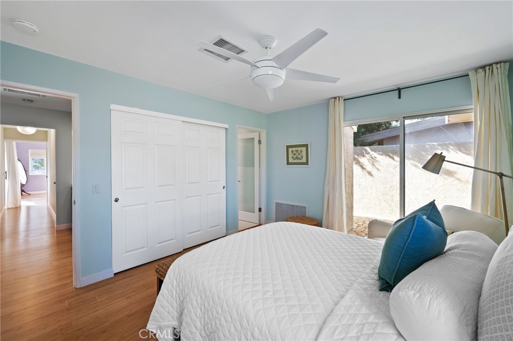 72543 Beavertail Street Palm Desert, CA 92260 - Photo 21 of 45 a bedroom with a large bed window and a ceiling fan