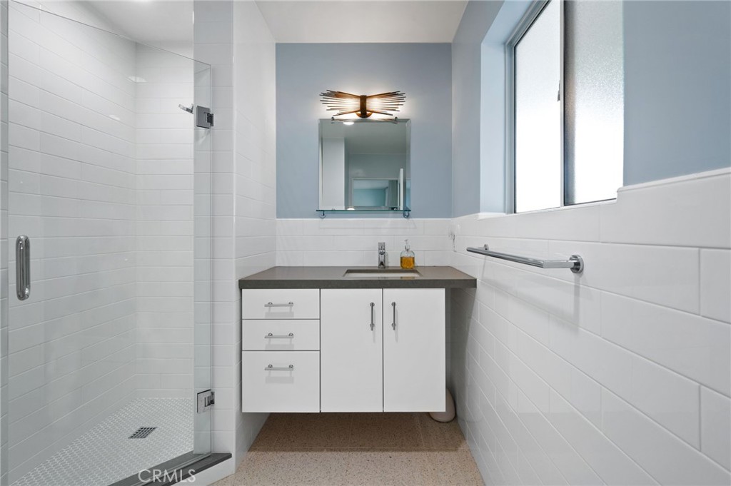 72543 Beavertail Street Palm Desert, CA 92260 - Photo 23 of 45 a bathroom with a granite countertop sink and a mirror