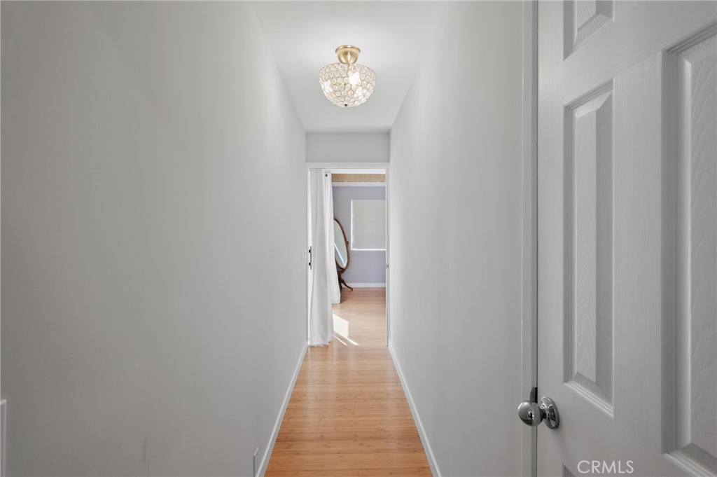72543 Beavertail Street Palm Desert, CA 92260 - Photo 24 of 45 a view of a hallway with wooden floor and a bathroom