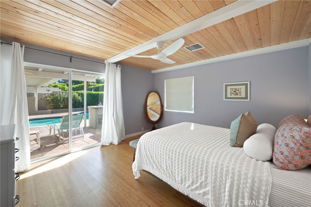 72543 Beavertail Street Palm Desert, CA 92260 - Photo 25 of 45 a bedroom with a bed and window with outer view