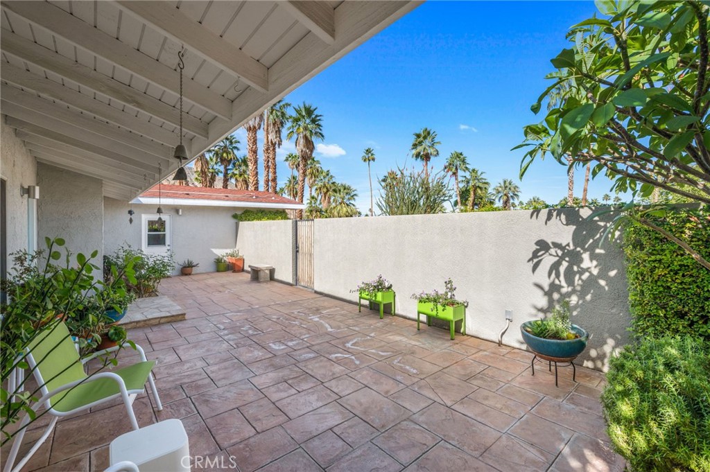 72543 Beavertail Street Palm Desert, CA 92260 - Photo 3 of 45 a front view of a house with a yard