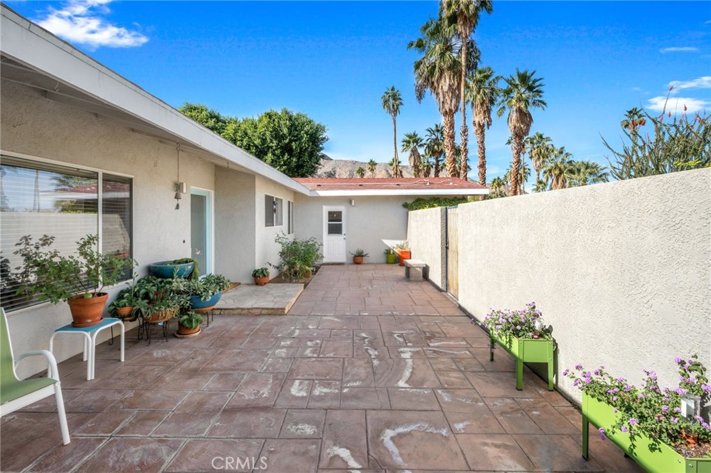72543 Beavertail Street Palm Desert, CA 92260 - Photo 4 of 45 a view of a patio with table and chairs potted plants