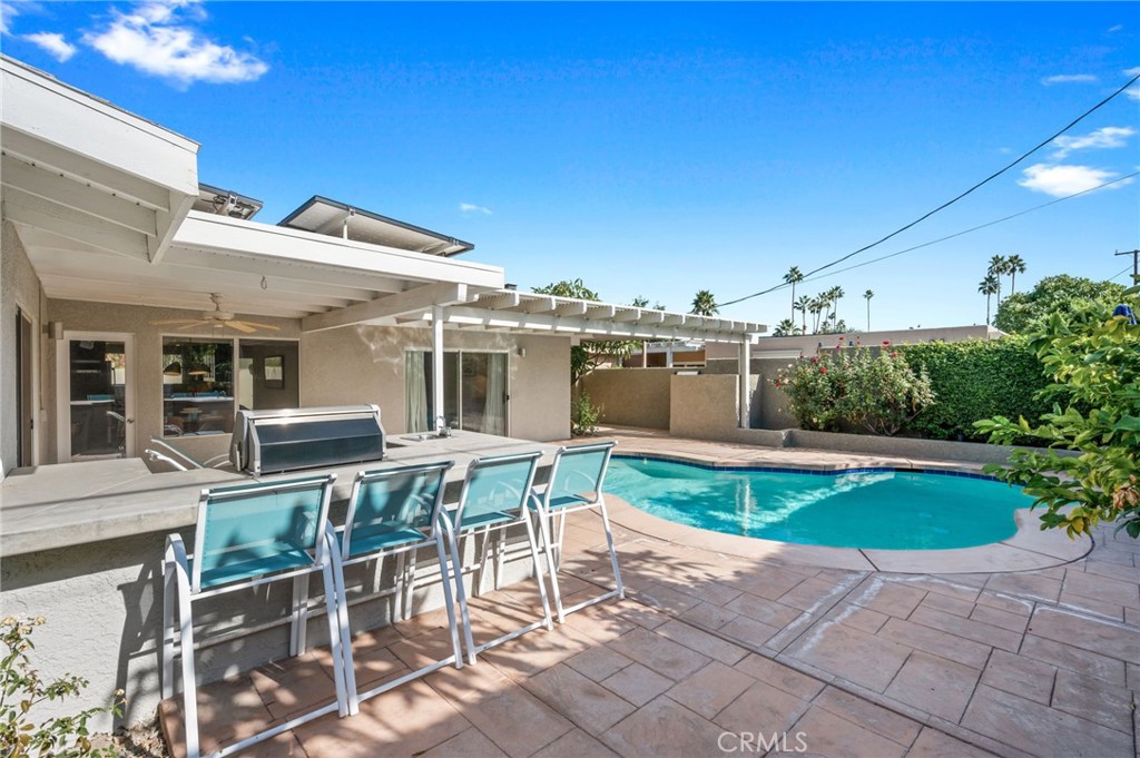 72543 Beavertail Street Palm Desert, CA 92260 - Photo 42 of 45 a patio with table and chairs and potted plants