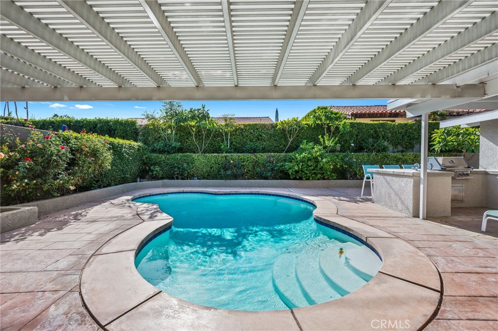 72543 Beavertail Street Palm Desert, CA 92260 - Photo 43 of 45 a view of a swimming pool with a patio and plants