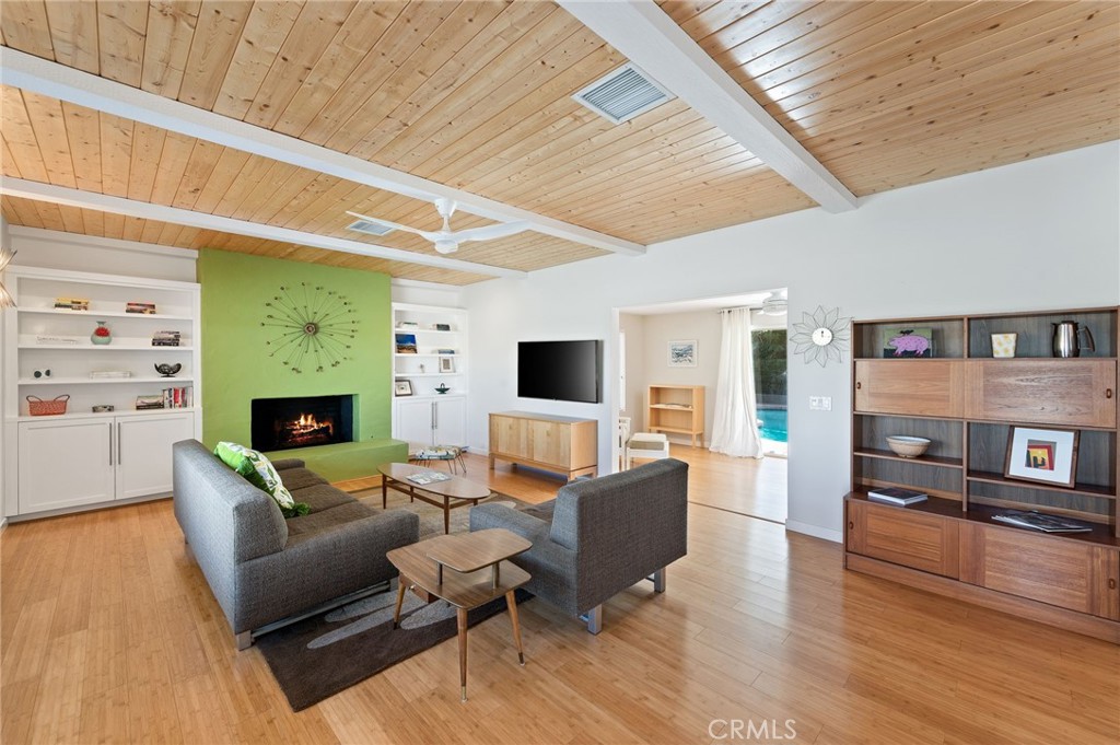 72543 Beavertail Street Palm Desert, CA 92260 - Photo 5 of 45 a living room with furniture a fireplace and a flat screen tv