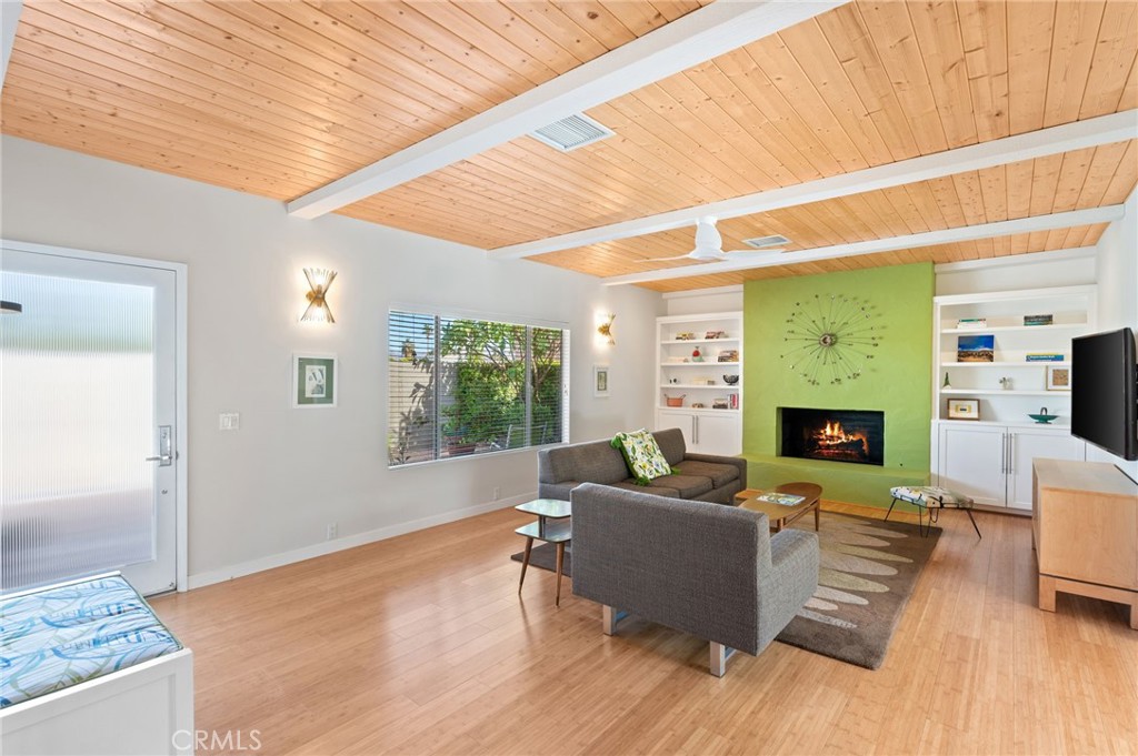 72543 Beavertail Street Palm Desert, CA 92260 - Photo 7 of 45 a living room with furniture large window and a fireplace