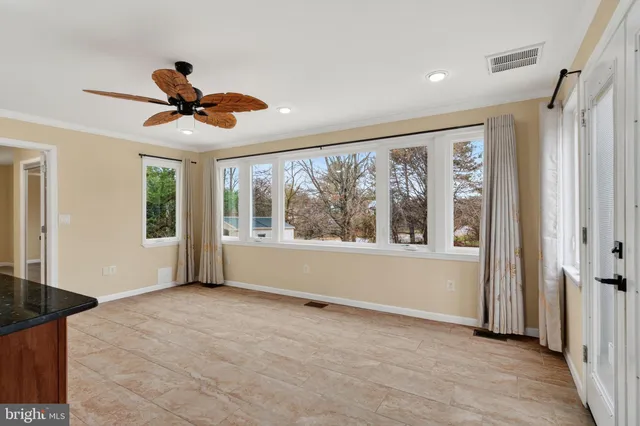 a living room with furniture appliances and wooden floor