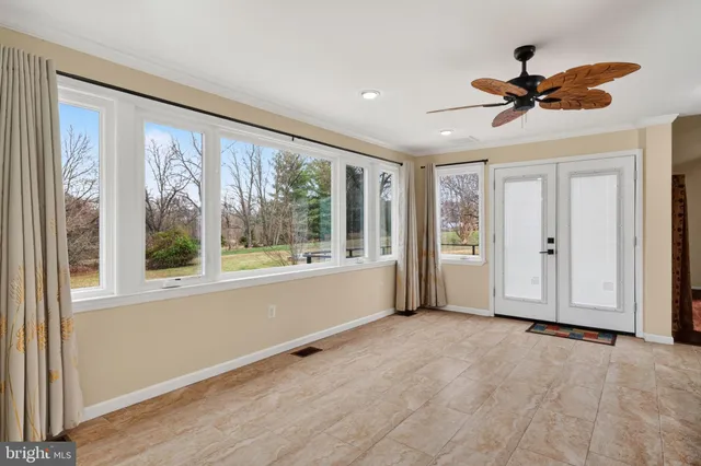 a view of a hallway with a livingroom and a bathroom with sink