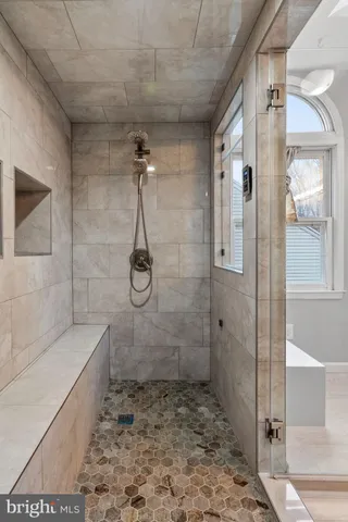 an empty room with a window and a ceiling fan