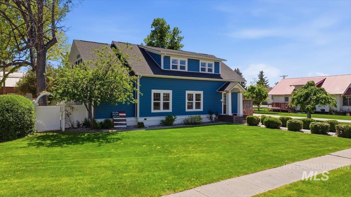 813 7th Street Rupert, ID 83350 - Photo 3 of 48 Blue siding exterior with white trim, a dark shingle roof, and a covered front entry
