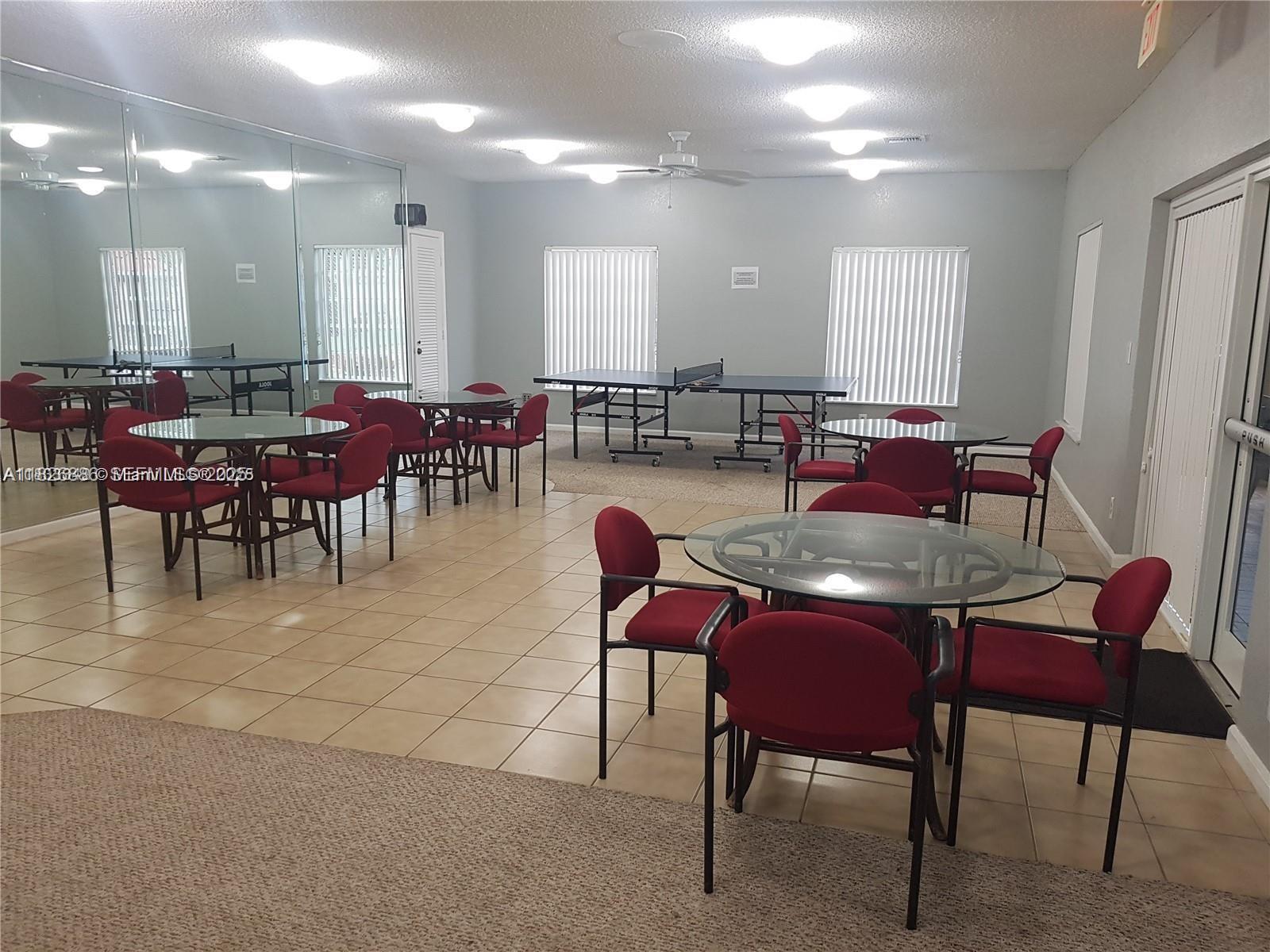 253 South Cypress Road, Unit 237 Pompano Beach, FL 33060 - Photo 22 of 23 a view of a dining room with furniture