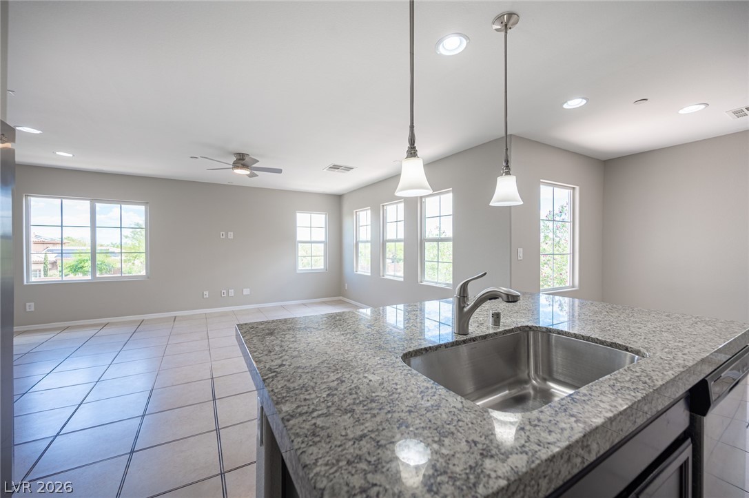9916 Sable Point Street Las Vegas, NV 89178 - Photo 37 of 73 A well-appointed kitchen island with a gleaming stainless steel sink, ready for culinary endeavors.