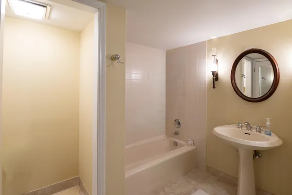 a bedroom with bed tv and window