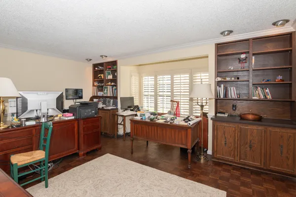 a bathroom with a granite countertop sink a toilet and a mirror