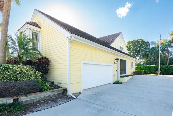 a house view with swimming pool in front of it