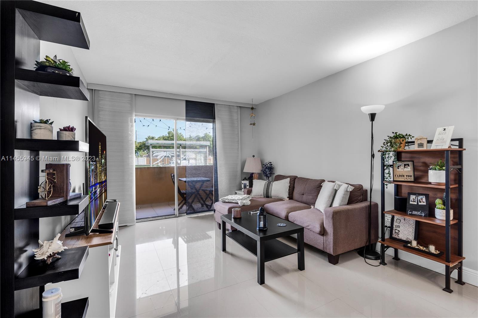 a living room with furniture and a book shelf