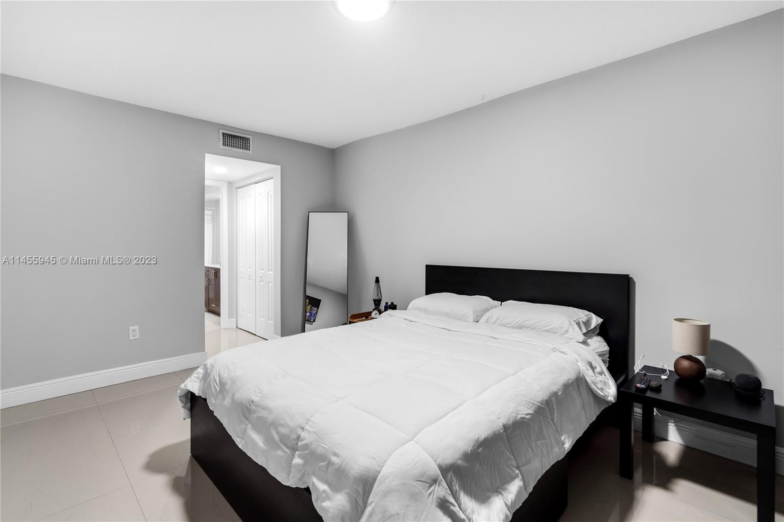 8990 Southwest 24th Street, Unit 15 Miami, FL 33165 - Photo 11 of 21 a bedroom with a bed and a lamp