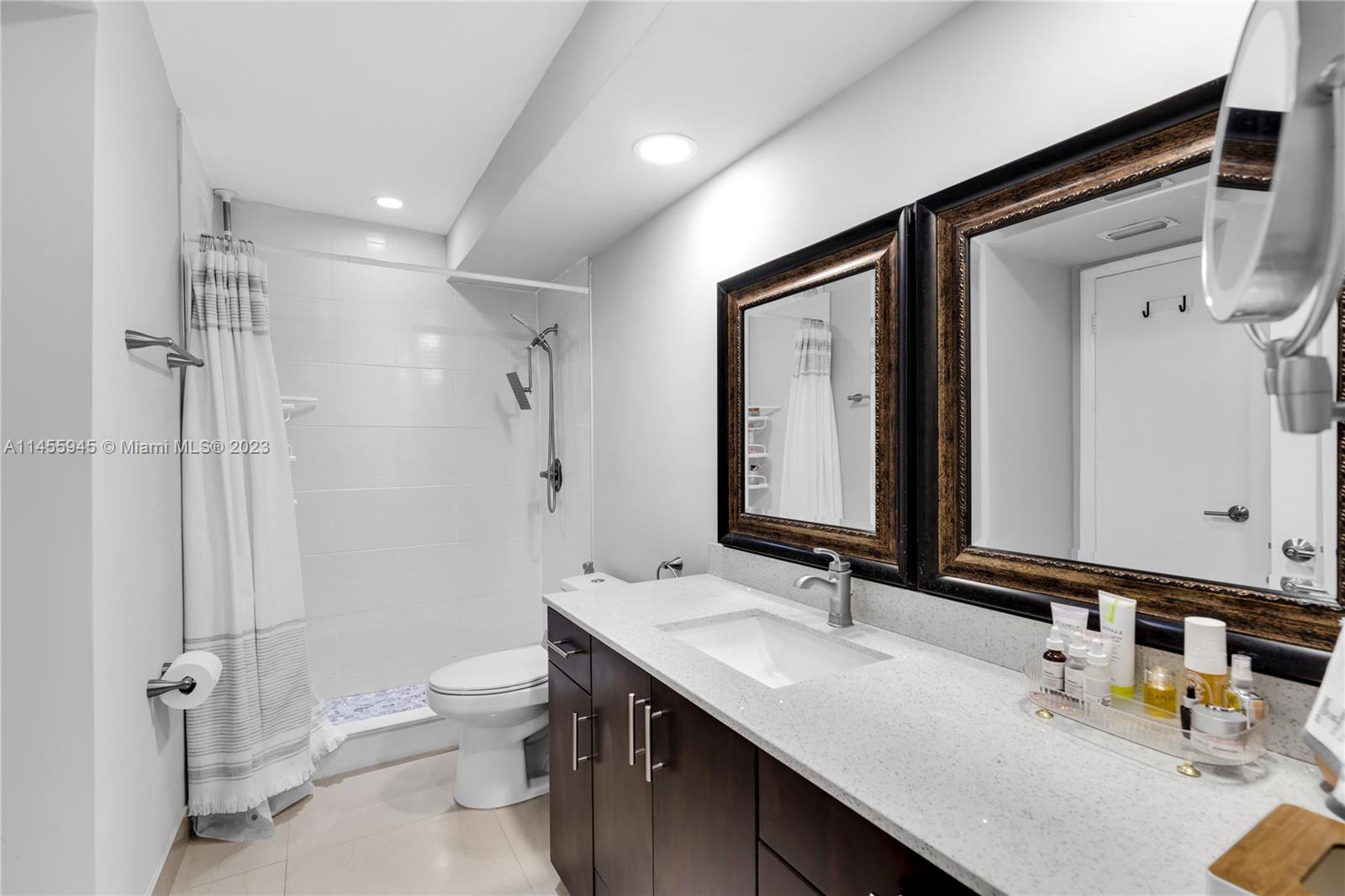 8990 Southwest 24th Street, Unit 15 Miami, FL 33165 - Photo 13 of 21 a bathroom with a granite countertop sink toilet and shower