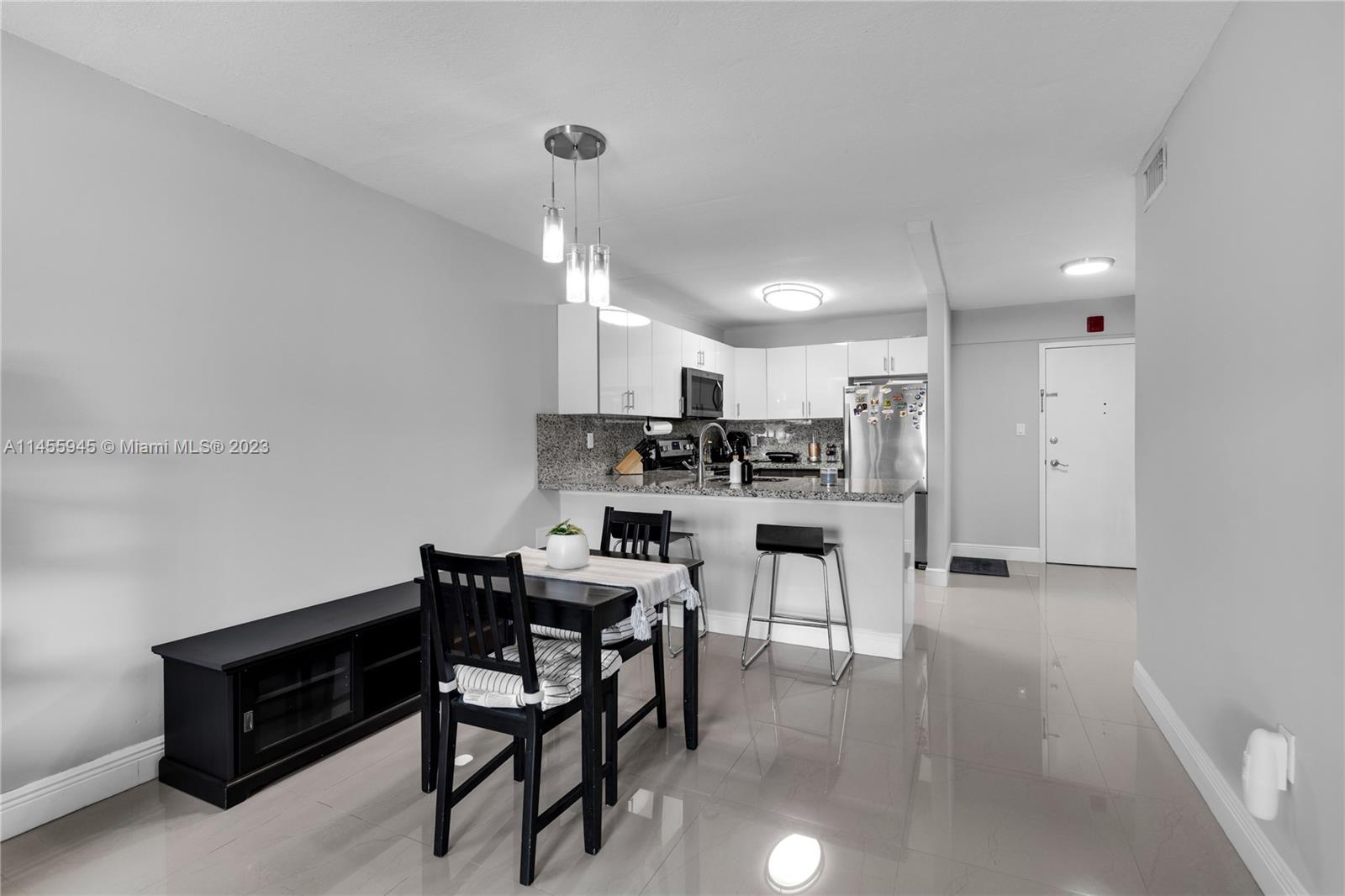 8990 Southwest 24th Street, Unit 15 Miami, FL 33165 - Photo 3 of 21 a kitchen with white cabinets and stainless steel appliances