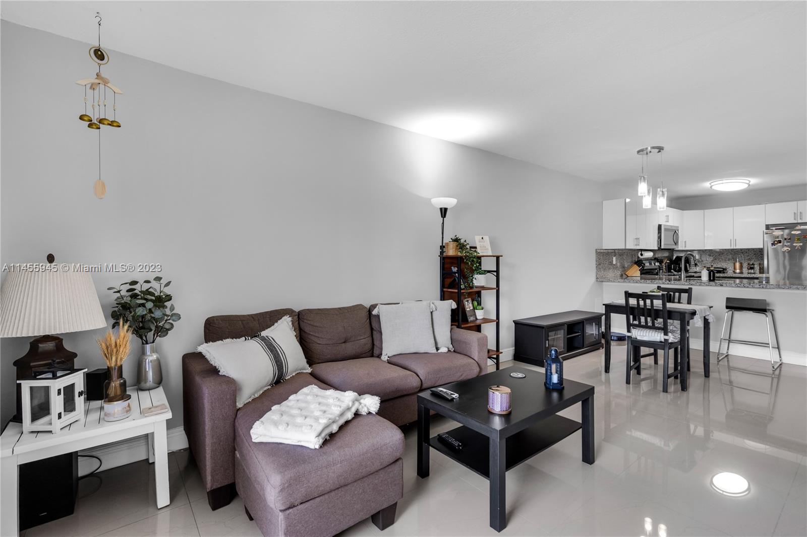 8990 Southwest 24th Street, Unit 15 Miami, FL 33165 - Photo 8 of 21 a living room with furniture and kitchen view