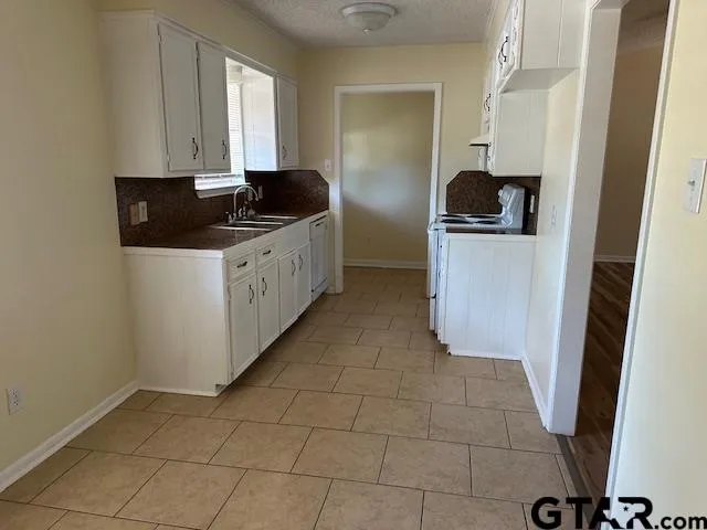 a kitchen with a sink and cabinets