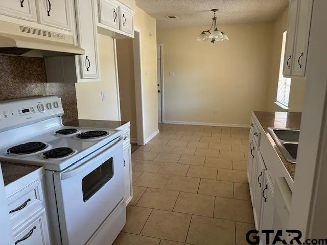 a kitchen with a stove and a refrigerator