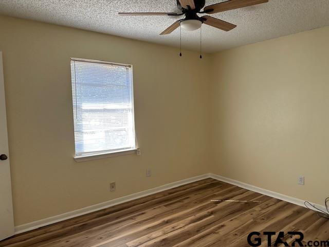 2100 Faulkner Street Tyler, TX 75701 - Photo 7 of 9 an empty room with a window and ceiling fan