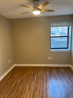 1529 South State Street, Unit 4B Chicago, IL 60605 - Photo 12 of 16 an empty room with wooden floor and windows