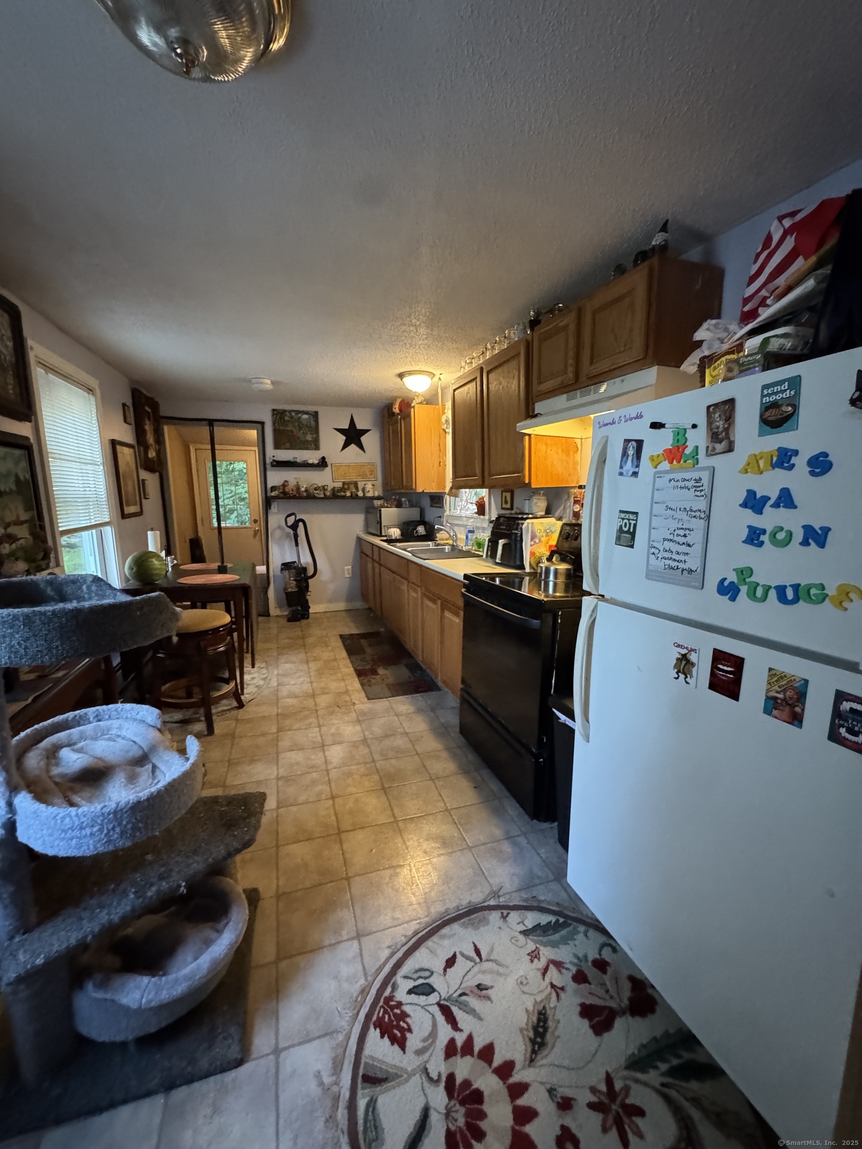 445 East Main Street Norwich, CT 06360 - Photo 5 of 6 a kitchen with stainless steel appliances a stove a sink and a refrigerator