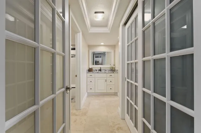 a en suite bathroom with a granite countertop sink and a mirror