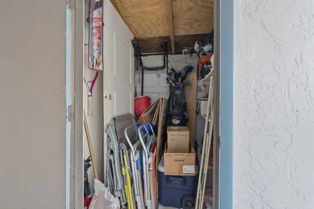 a front view of a house with a yard and potted plants