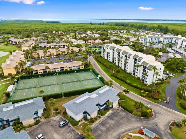 an aerial view of a house with a swimming pool patio and lake view