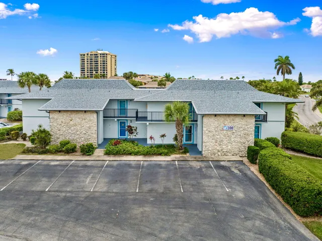 an aerial view of a house with a swimming pool patio and lake view