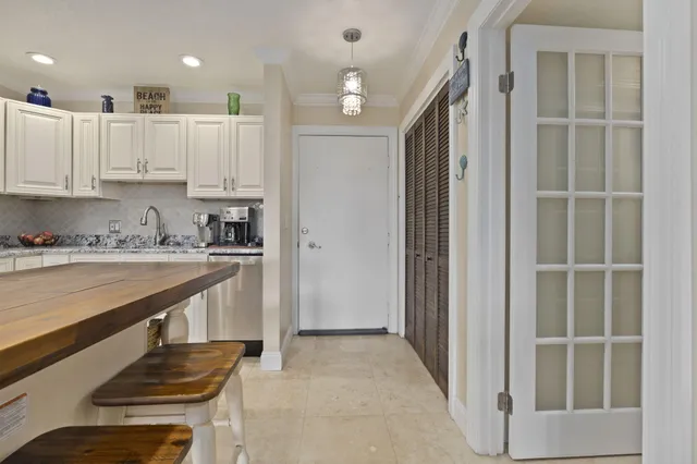 a kitchen with a stove a refrigerator and a sink with wooden floor