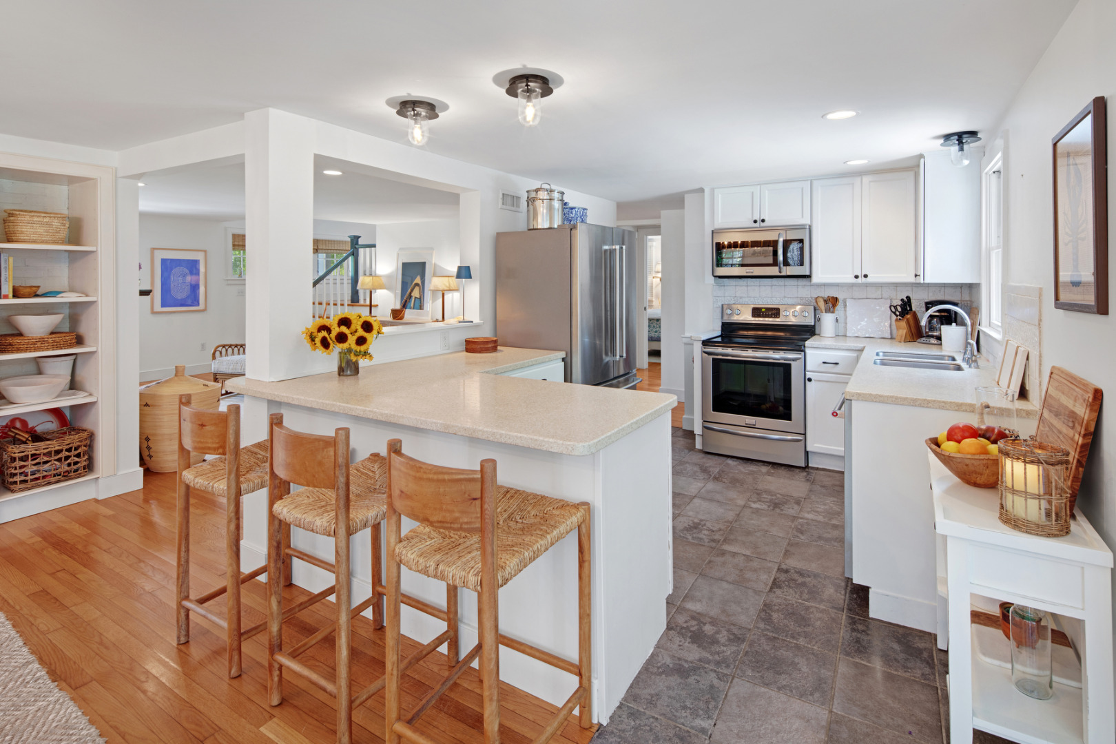 5 Hillman Drive Edgartown, MA 02539 - Photo 14 of 34 a kitchen with stainless steel appliances refrigerator stove dining table and chairs