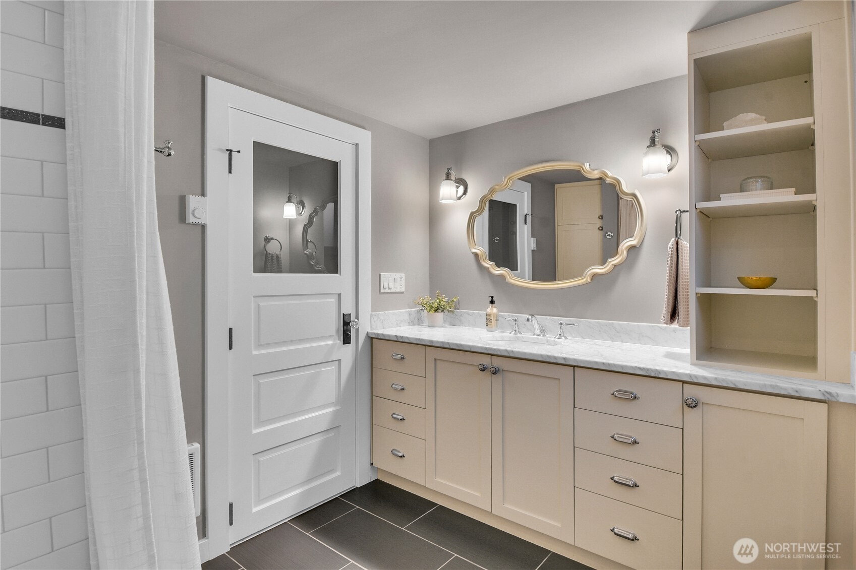 110 Smith Street Seattle, WA 98109 - Photo 26 of 35 a bathroom with a granite countertop sink vanity and mirror