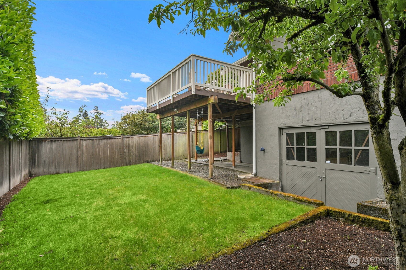 110 Smith Street Seattle, WA 98109 - Photo 33 of 35 a view of a house with a yard and wooden fence