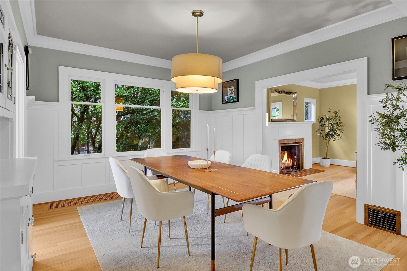 110 Smith Street Seattle, WA 98109 - Photo 6 of 35 a dining room with furniture a chandelier and wooden floor