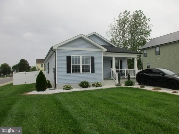 a front view of a house with a garden and yard