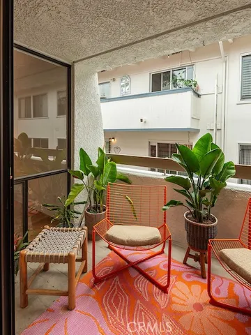 a dining room with furniture and a potted plant
