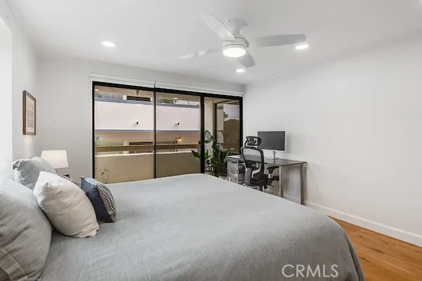 a large bedroom with a bed and large window