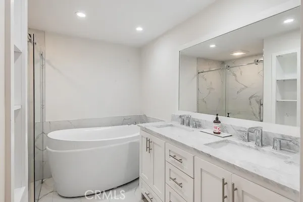 a bathroom with a tub sink and mirror