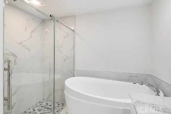 a bathroom with a bathtub and shower