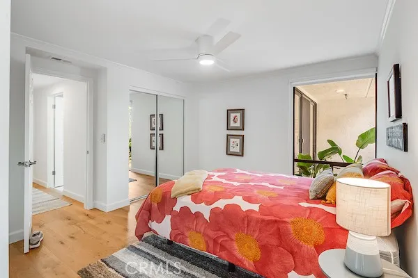 a bedroom with a bed and wooden floor